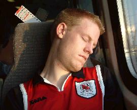 Dreaming of a Bazza headed goal? Chris Stockdale snoozes on the way home to London after the 1-0 defeat to Oxford in 2002